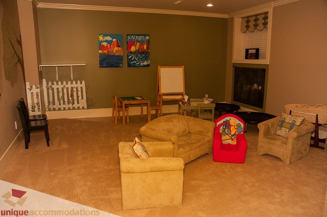 Playroom with colorful art, toys, and a chalkboard. - 3035 Newmarket Drive, North Vancouver