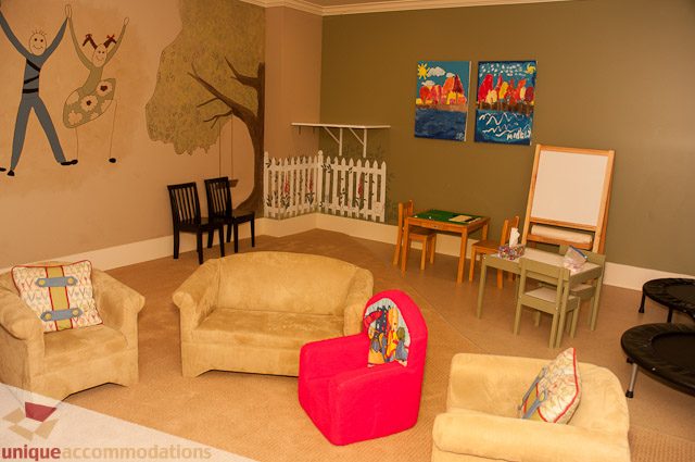 Bright playroom with colorful murals, chairs, and easel. - 3035 Newmarket Drive, North Vancouver