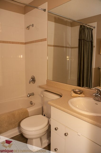 Bathroom with beige countertops and a shower. - 3035 Newmarket Drive, North Vancouver