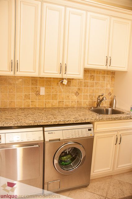 Bright kitchen with granite countertops and stainless steel appliances. - 3035 Newmarket Drive, North Vancouver