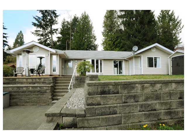Furnished 5-bedroom + den house with stone patio and trees in the background. - 1889  Alderlynn Drive, North Vancouver