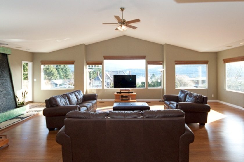 Bright living room with hardwood floors, large windows, and a city view. - 967 Roslyn Blvd., North Vancouver