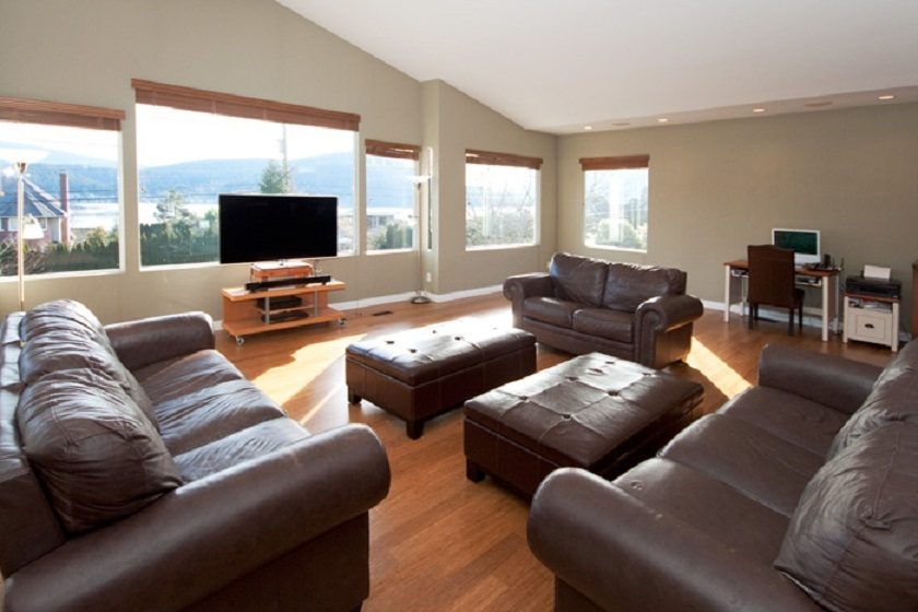Bright living room with large windows, hardwood floors, and a city view. - 967 Roslyn Blvd., North Vancouver