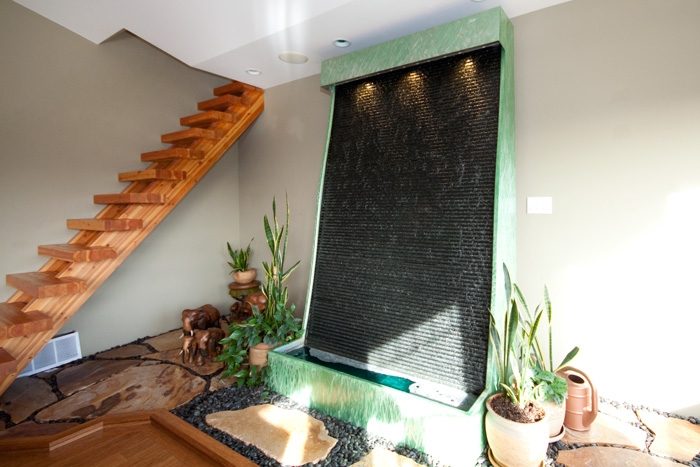 Staircase with natural wood and a water feature in a spacious, modern living area. - 967 Roslyn Blvd., North Vancouver