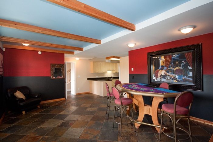 Bright game room with colorful murals, bar stools, and a large TV. - 967 Roslyn Blvd., North Vancouver