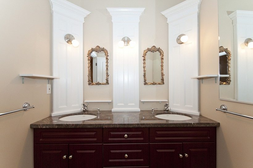 Bathroom with dual sinks, ornate mirrors, and marble countertops. - 967 Roslyn Blvd., North Vancouver