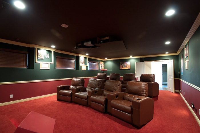 Luxurious home theater with plush leather recliners and red carpeting. - 967 Roslyn Blvd., North Vancouver
