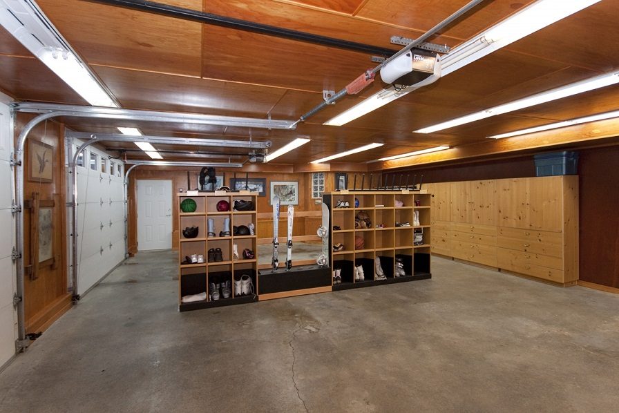 Furnished garage with wooden shelves, ski equipment, and storage units. - 967 Roslyn Blvd., North Vancouver