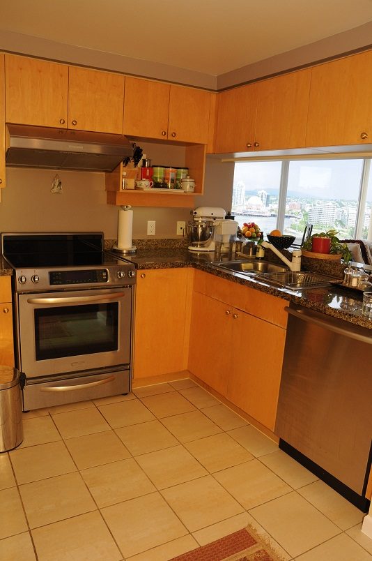 Bright kitchen with granite countertops, stainless steel appliances, and a city view. - 2002 - 1228 Marinaside Crescent, Vancouver Downtown