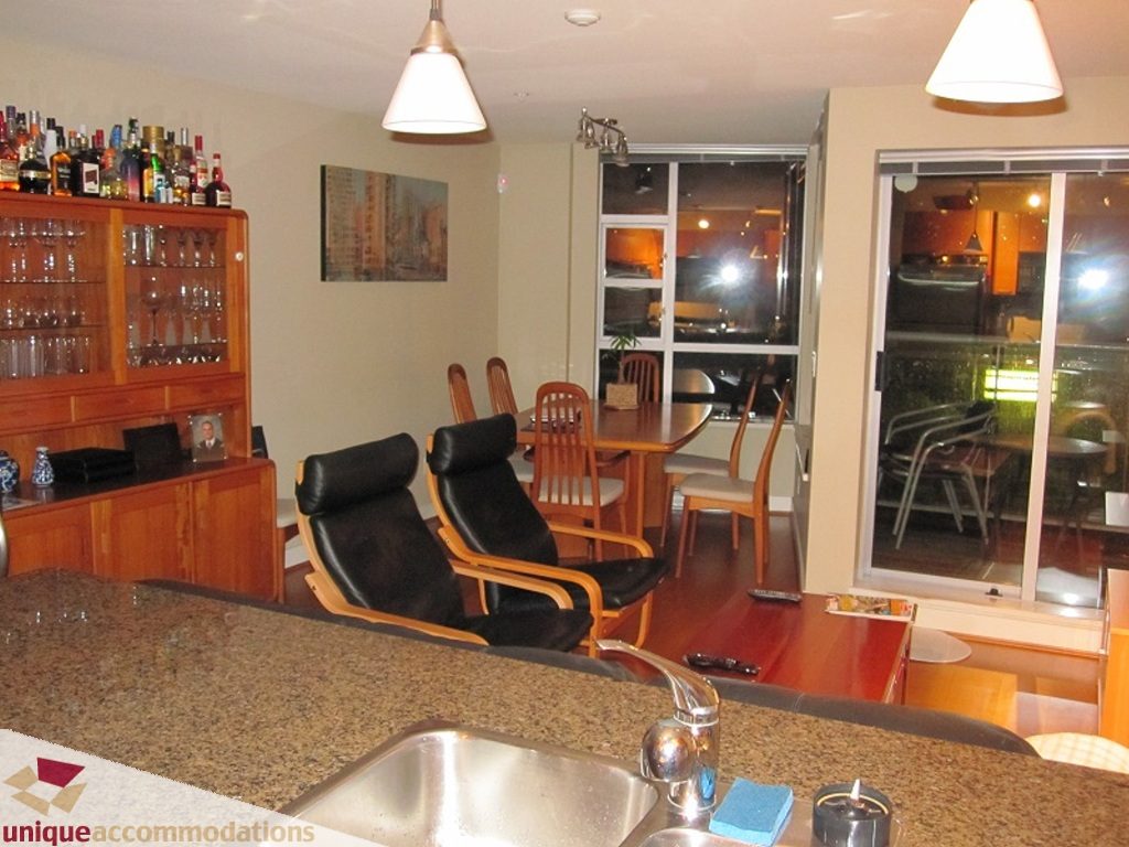 Furnished kitchen with granite countertops, hardwood floors, and a city view. - 6-1250 West 6th Ave, Vancouver West Side