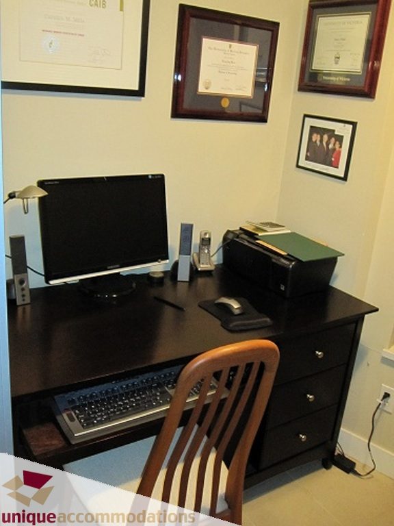 Furnished office with black desk, computer, and framed certificates on wall. - 6-1250 West 6th Ave, Vancouver West Side