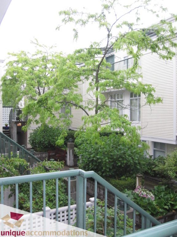 Balcony with greenery and views of neighboring buildings. - 306-3727 West 10th Ave, Vancouver West Side