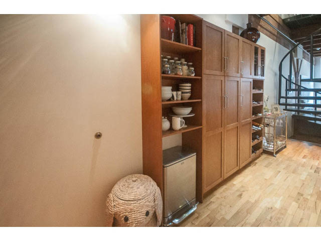Bright kitchen with wooden cabinets, hardwood floors, and a modern design. - 410 - 550 Beatty Street, Vancouver Downtown