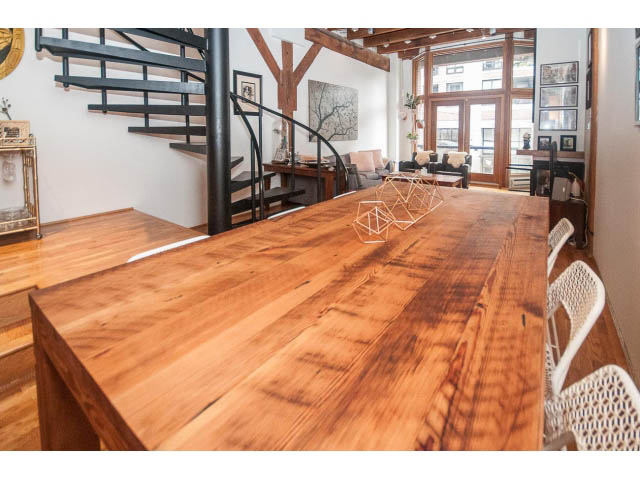 Spacious loft with hardwood floors and a large wooden dining table. - 410 - 550 Beatty Street, Vancouver Downtown