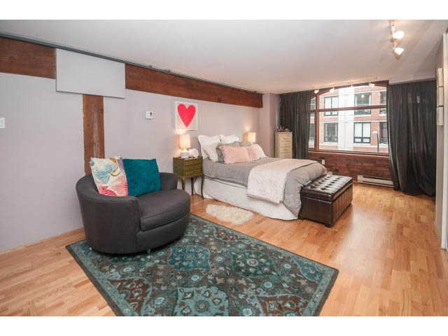 Furnished 1-bedroom loft with hardwood floors, city view, and cozy seating area. - 410 - 550 Beatty Street, Vancouver Downtown