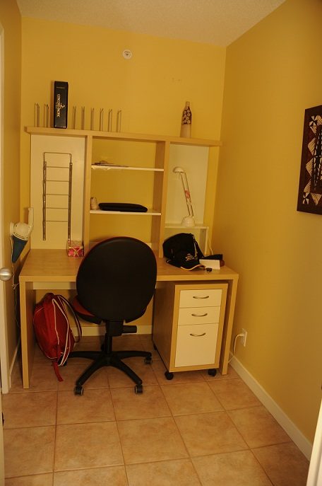 Bright study area with yellow walls, tiled floor, desk, chair, and shelves. - 1501 -1077 Marinaside Crescent, Vancouver Downtown