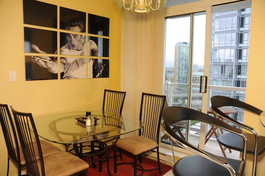 Furnished dining area with city view and modern decor. - 1501 -1077 Marinaside Crescent, Vancouver Downtown
