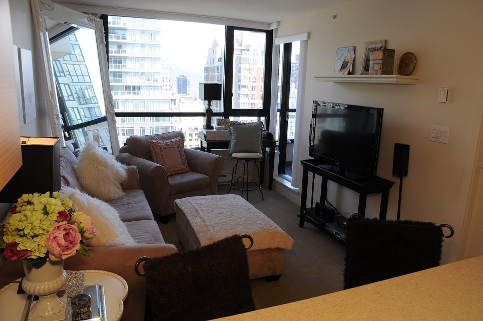 Bright living room with city view, modern decor, and a cozy ambiance. - 2605 - 928 Homer Street, Vancouver Downtown