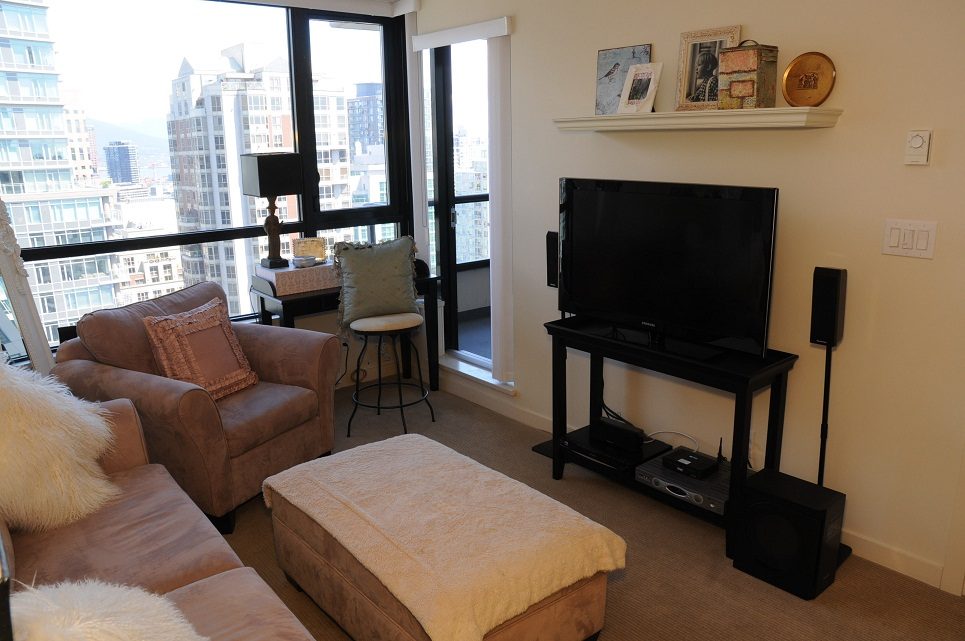 Bright living room with city view, large windows, and modern furniture. - 2605 - 928 Homer Street, Vancouver Downtown