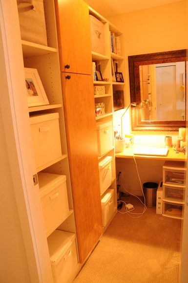 Bright bedroom with built-in shelving and desk area, warm lighting. - 2605 - 928 Homer Street, Vancouver Downtown