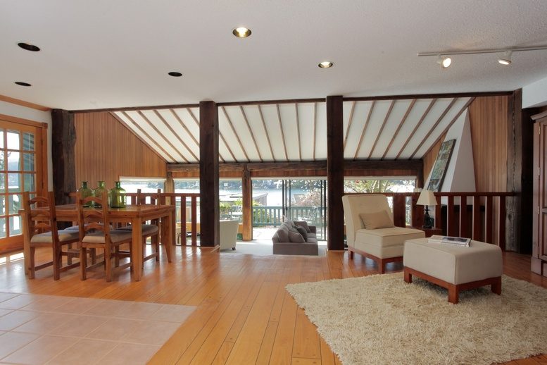 Open-concept living area with hardwood floors, modern furniture, and a city view. - 2758 Panorama Drive, North Vancouver
