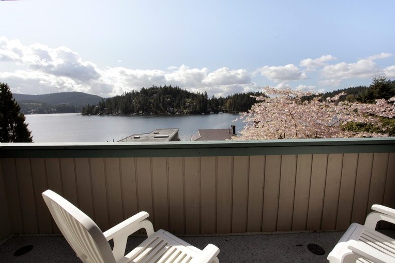 Balcony with cherry blossoms and lake view, furnished chairs. - 2758 Panorama Drive, North Vancouver