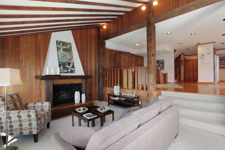 Spacious living room with wood beams, modern furniture, and a cozy fireplace. - 2758 Panorama Drive, North Vancouver