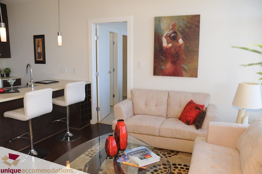 Furnished living room with white couch, glass coffee table, and modern decor. - 3401 - 888 Homer Street, Vancouver Downtown