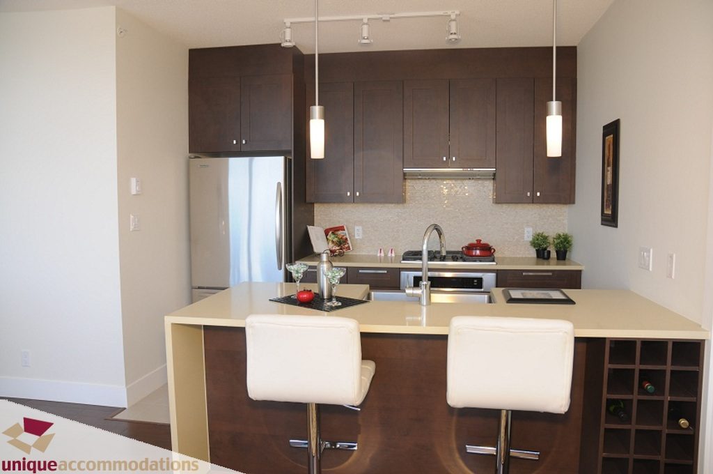 Bright kitchen with modern cabinetry, white countertops, and a wine rack. - 3401 - 888 Homer Street, Vancouver Downtown