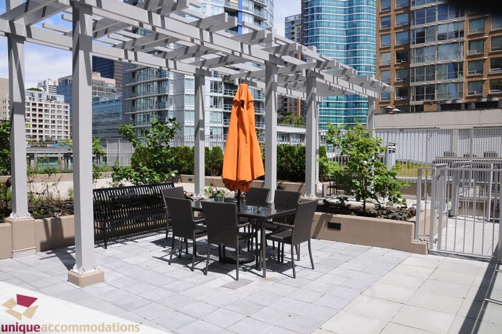 Furnished patio with modern furniture, city view, and pergola. - 3401 - 888 Homer Street, Vancouver Downtown