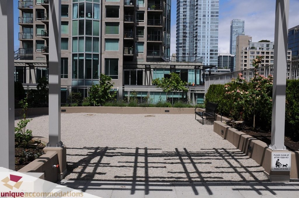 Furnished rooftop patio with city view and greenery. - 3401 - 888 Homer Street, Vancouver Downtown