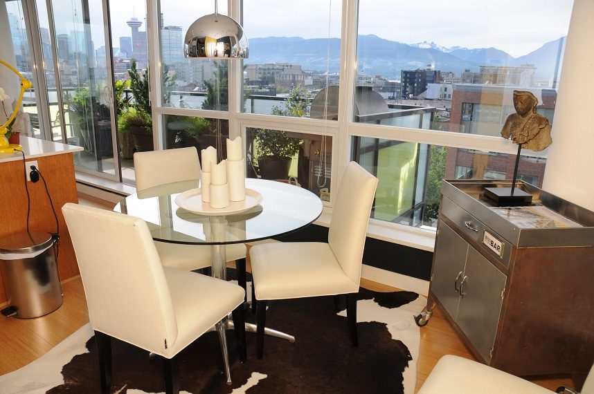Bright dining area with cowhide rug, city view, and modern decor. - 903-718 Main Street, Vancouver Downtown