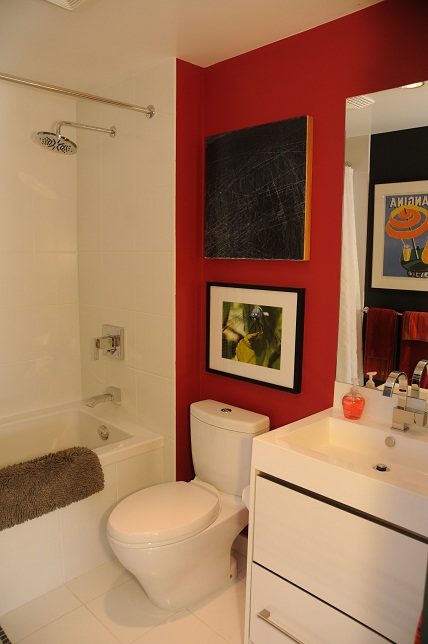 Bathroom with red accent wall, modern decor, and white fixtures. - 903-718 Main Street, Vancouver Downtown