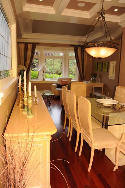 Elegant dining room with hardwood floors, glass table, and candle centerpiece. - 4069 West 37th Ave, Vancouver West Side