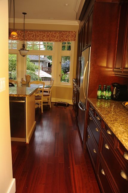 Bright kitchen with granite countertops, hardwood floors, and a city view. - 4069 West 37th Ave, Vancouver West Side