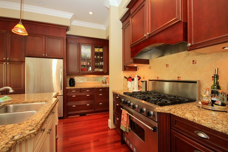 Bright kitchen with granite countertops, hardwood floors, and stainless steel appliances. - 4069 West 37th Ave, Vancouver West Side