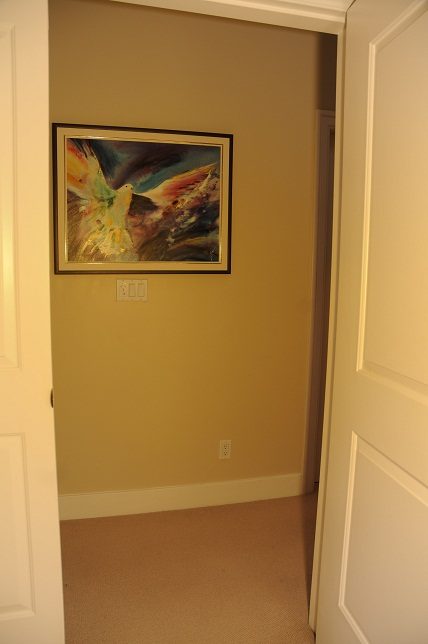 Framed abstract art on beige wall, hallway leading to bedrooms. - 4069 West 37th Ave, Vancouver West Side
