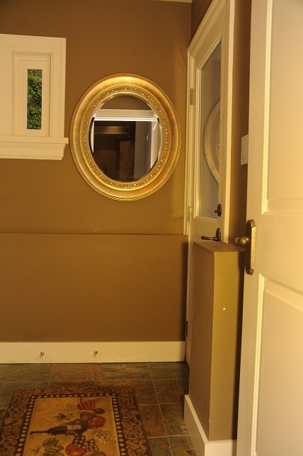 Foyer with decorative mirror, tiled floor, and white door. - 4069 West 37th Ave, Vancouver West Side