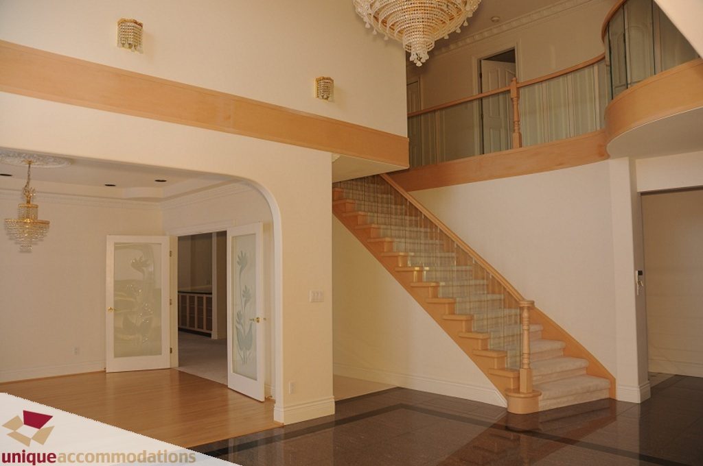 Stunning entryway with grand staircase and elegant chandelier. - 4139 Citadel Court, North Vancouver
