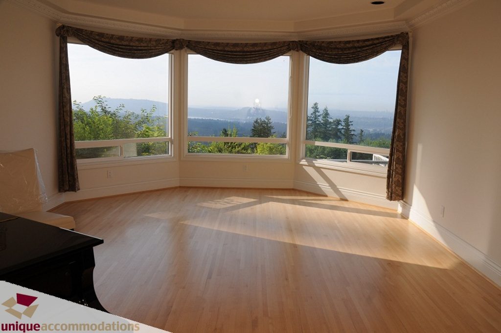 Bright sunlit bay window with hardwood floors and city view. - 4139 Citadel Court, North Vancouver