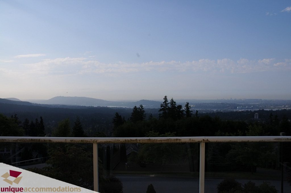 Balcony with city view and lush greenery, perfect for relaxation. - 4139 Citadel Court, North Vancouver