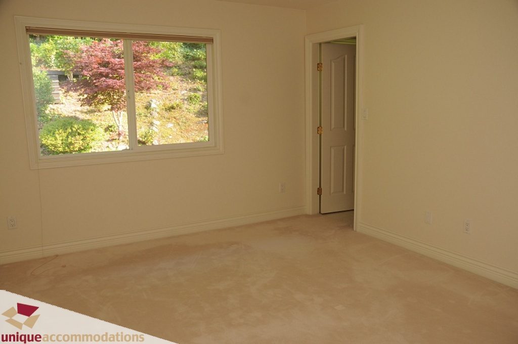 Bright bedroom with large window and carpeted floor. - 4139 Citadel Court, North Vancouver