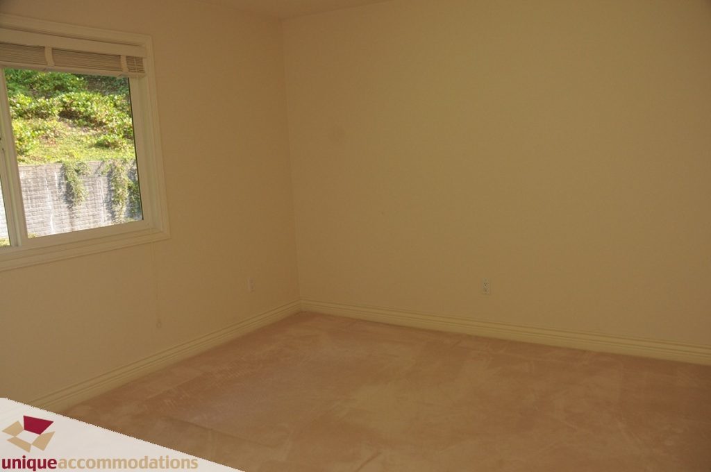Empty bedroom with carpeted floor and window view. - 4139 Citadel Court, North Vancouver