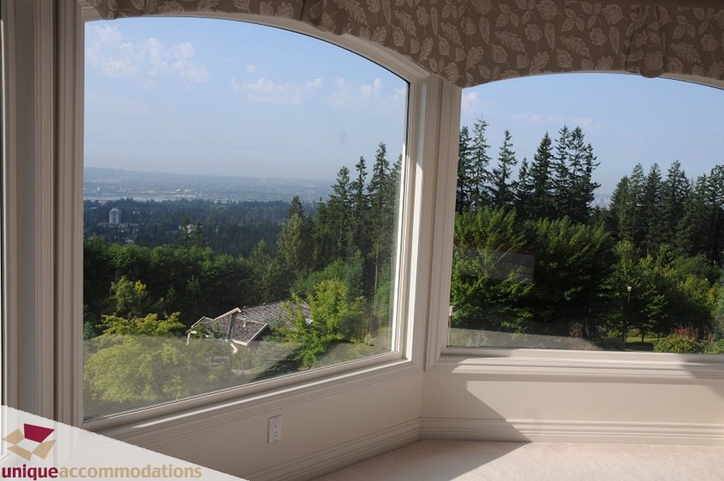 Bright corner window with city view and lush greenery, perfect for relaxation. - 4139 Citadel Court, North Vancouver