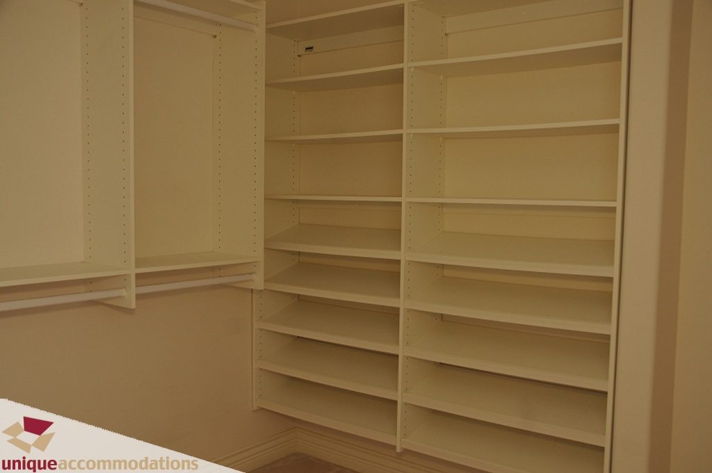 Empty walk-in closet with built-in shelves and storage. - 4139 Citadel Court, North Vancouver