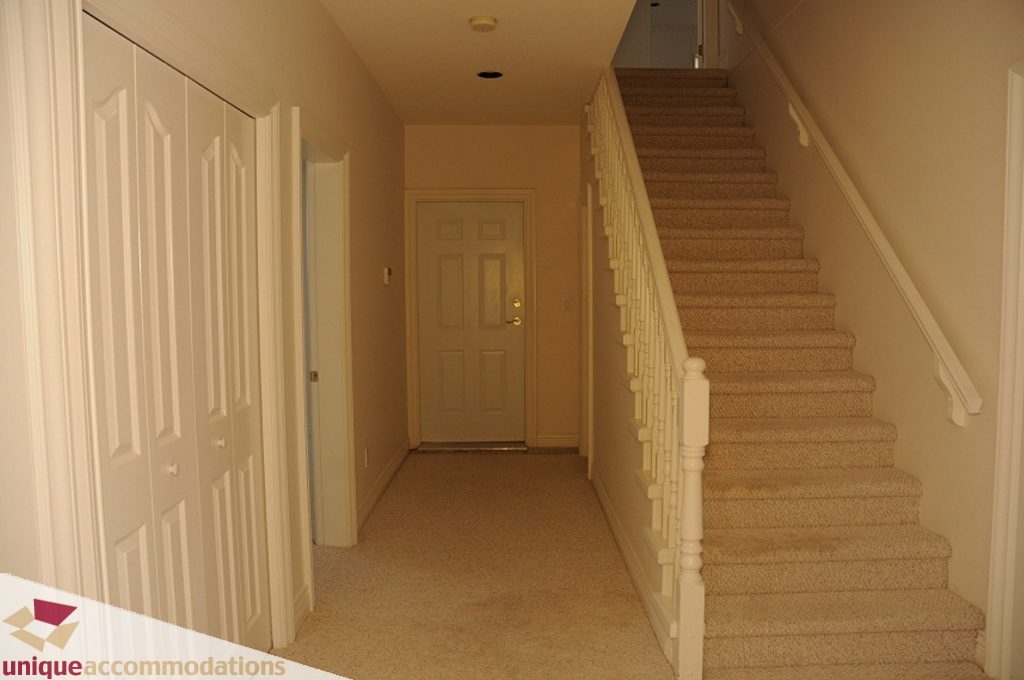 Staircase leading to upper floor with carpeted steps and white railings. - 4139 Citadel Court, North Vancouver