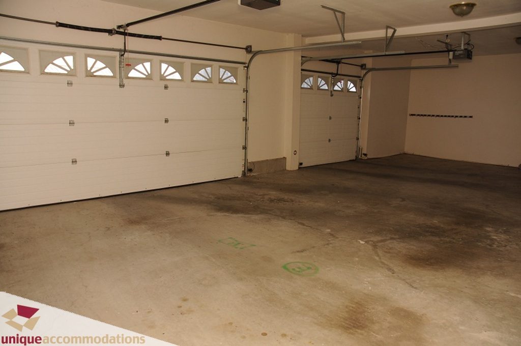 Empty garage with concrete floor and double doors. - 4139 Citadel Court, North Vancouver