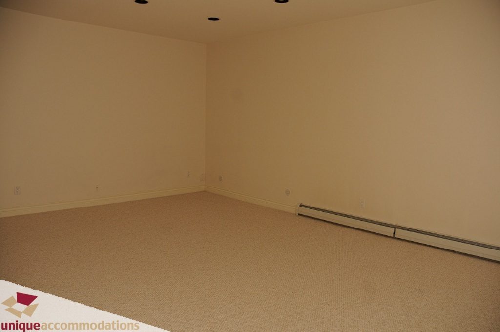 Empty bedroom with carpeted floor and recessed lighting. - 4139 Citadel Court, North Vancouver
