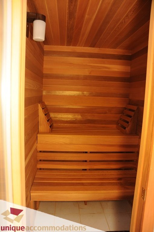 Spacious wooden sauna with slatted seating and a warm ambiance. - 4139 Citadel Court, North Vancouver
