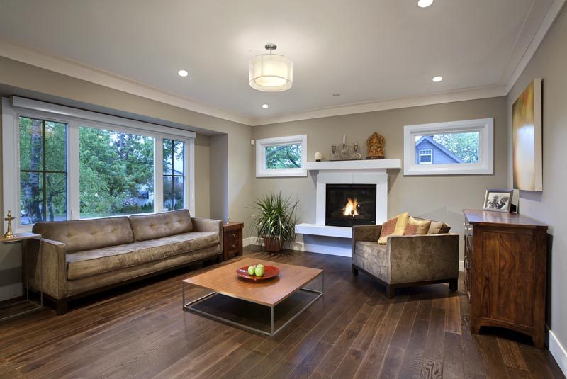 Living room with hardwood floors, modern furniture, and a fireplace. - 4104 West 12th Avenue, Vancouver West Side